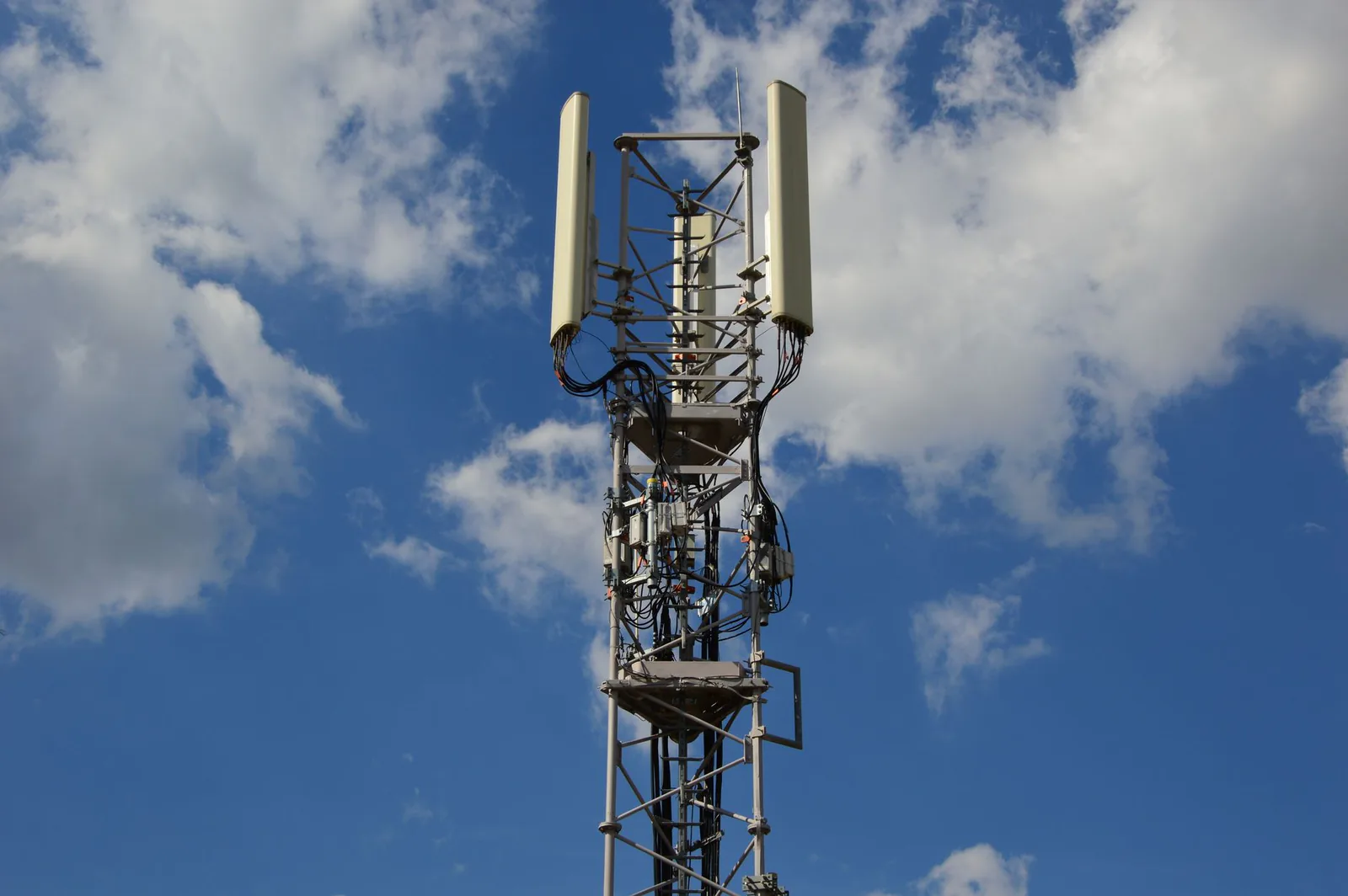 Cellular communication tower against blue sky